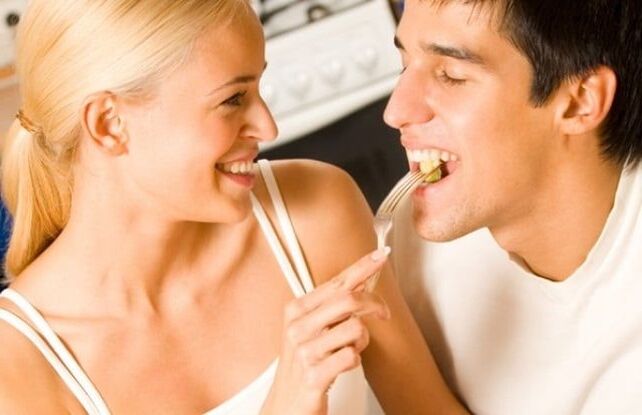 Girl feeds man product to increase potency